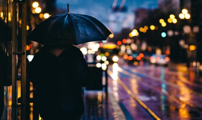 A person in a rain in the evening
