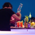Barman making a drink for a lady