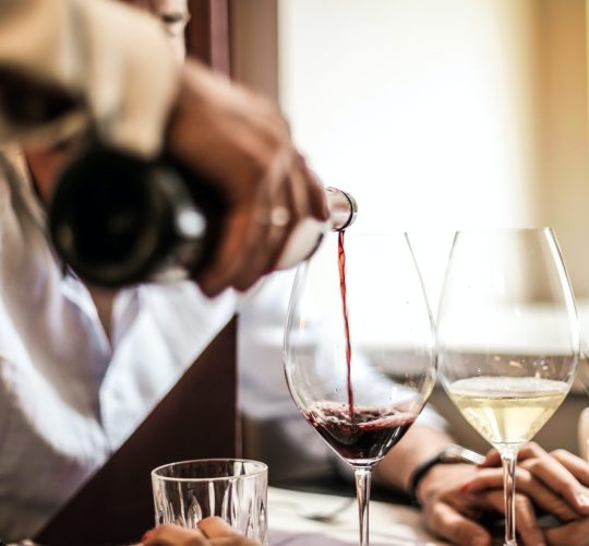 Pouring red wine in a glass